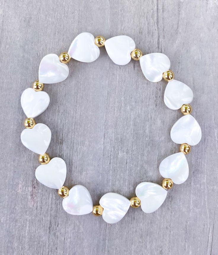 Natural White Shell Heart Bracelet 🤍 4mm 18k Gold Balls with 10mm white shell hearts The cutest layering piece ✨  CARING TIPS FOR YOUR JEWELRY ⭐️Treat and store with care. ⭐️ For longevity, avoid exposing your jewelry to water. ⭐️ Avoid having direct contact with lotions, perfumes, sanitizers as these chemicals may cause discoloration of your jewelry. White Pearl Bracelet With Heart Charm For Wedding, White Heart-shaped Pearl Bracelet For Wedding, White Pearl Wedding Bracelet With Heart Charm, White Heart Beads Bracelet For Weddings, White Heart-shaped Beaded Bracelets For Wedding, White Heart-shaped Bracelet For Weddings, White Heart Bracelet For Wedding, White Heart-shaped Wedding Bracelet, Gold Heart-shaped Pearl Bracelet For Valentine's Day