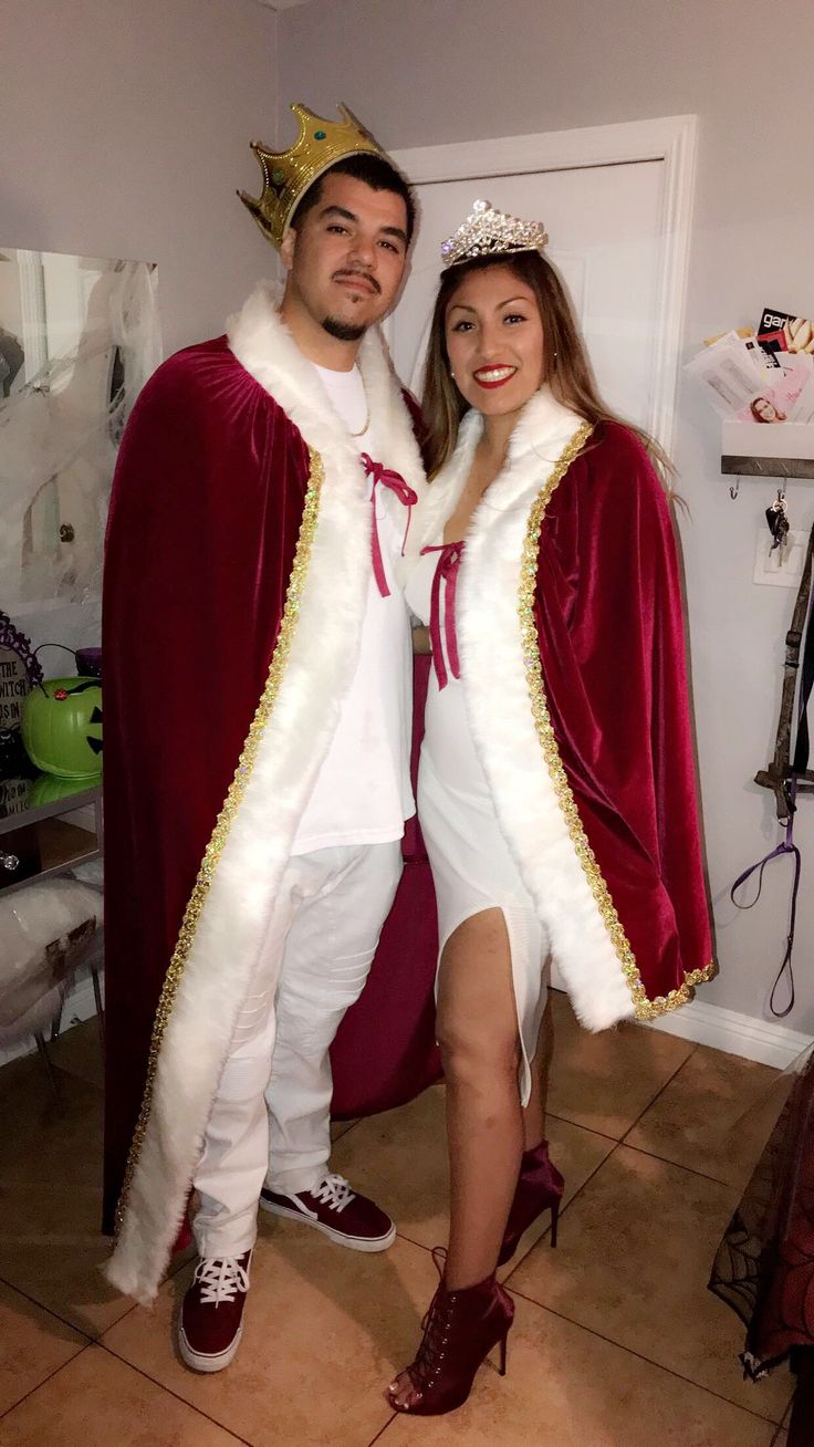 a man and woman dressed up as king and queen posing for the camera in costume