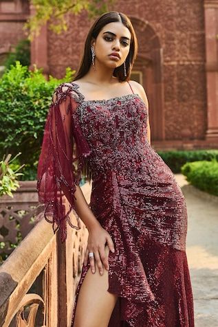 Maroon gown with sequin, cutdana, bead embroidery and draped on one sleeve. - Aza Fashions One-shoulder Gown For Gala And Festive Occasions, One-shoulder Festive Gown For Gala, Festive One Shoulder Gala Gown, Elegant Draped Dress With Dupatta, Festive Gown With Traditional Draped Sleeves, Festive Gown With Draped Sleeves, Festive Evening Dress With Draped Sleeves, Festive Draped Gown With Draped Sleeves, Traditional Drape Dress With Sheer Dupatta For Gala