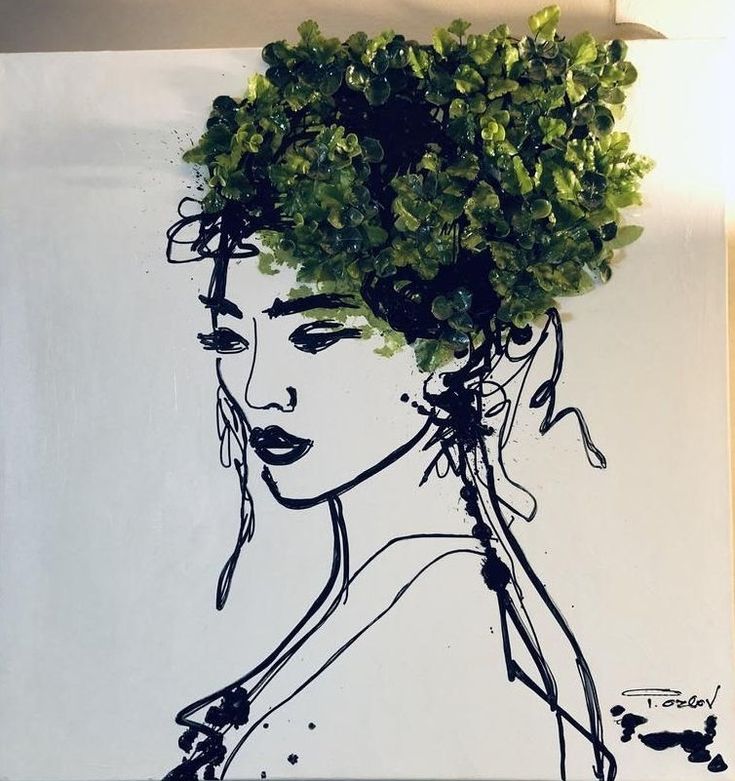 a drawing of a woman's face with green leaves on her head is shown