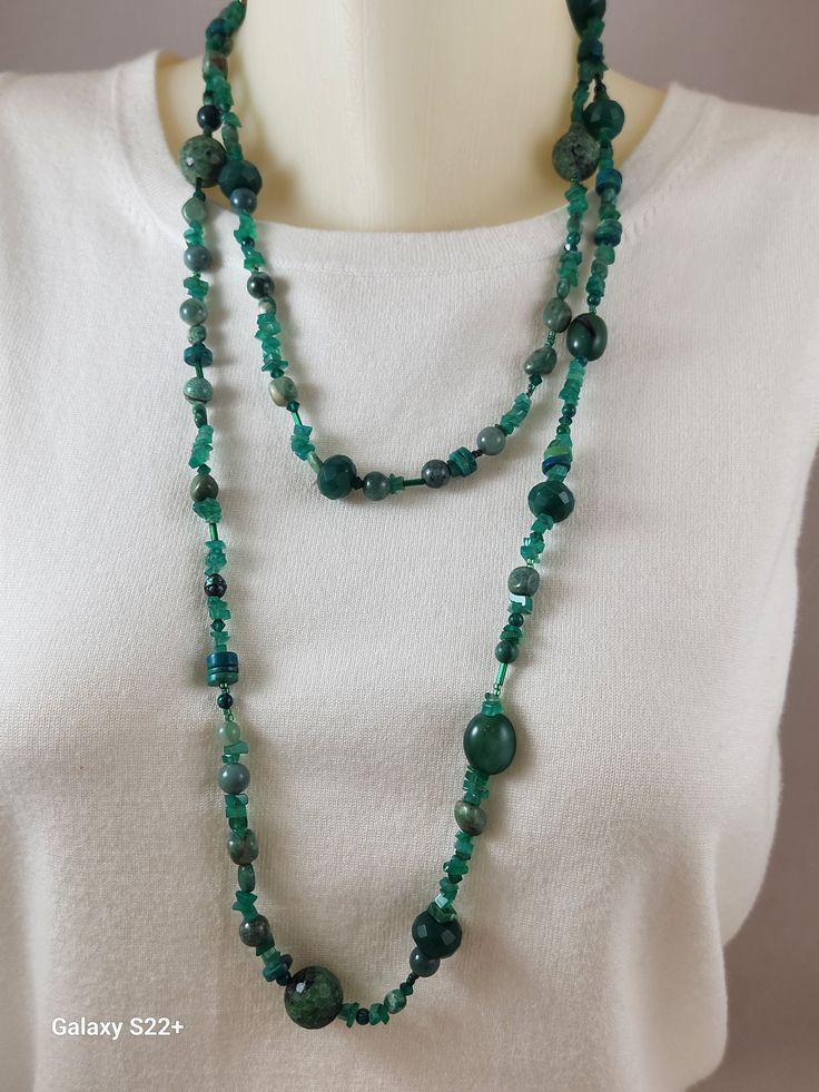 This necklace is one of my specialties.  It is a mixed lot of deep green natural stones.  There are emerald chips, green aventurine, Pearls, Ruby Zoisite, Chrysocolla, Swarovski Bicone crystals, Jade, all strung in a random fashion. It is strung on nylon fishing line, making it very strong.  There is no clasp, just wrap and go, Green Emerald Necklace With Polished Jade Beads, Green Chrysocolla Gemstone Beads Jewelry, Green Chrysocolla Round Bead Necklaces, Green Gemstone Beaded Necklace For Healing, Bohemian Green Aventurine Necklaces, Green Chrysocolla Round Beads Necklace, Bohemian Green Aventurine Necklace, Green Emerald Bohemian Necklace, Green Beaded Necklaces With Natural Stones For Jewelry Making