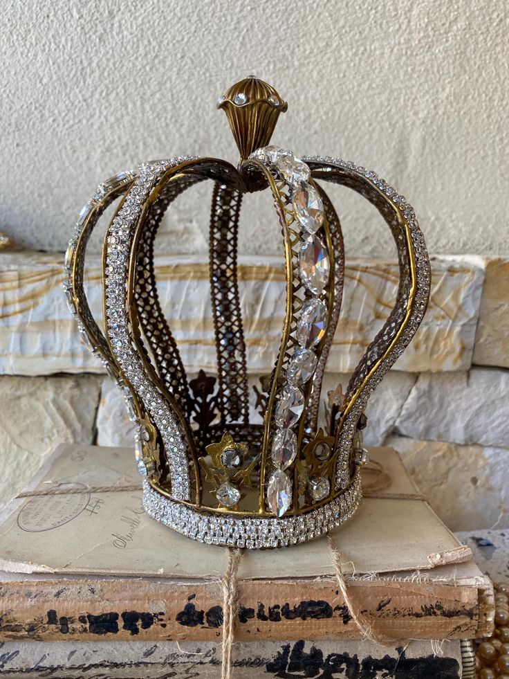 a crown sitting on top of a stack of books