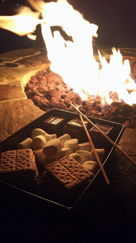 marshmallows are being cooked over an open fire