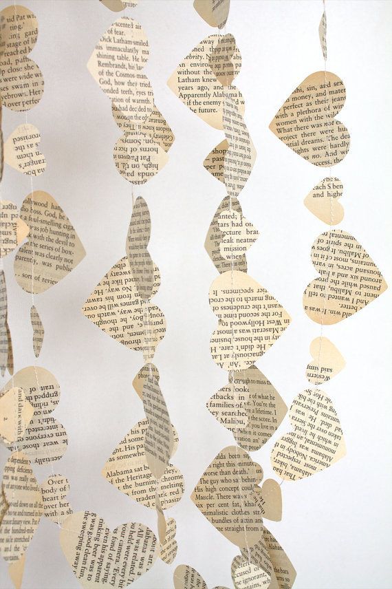 paper hearts hanging from strings made out of old book pages