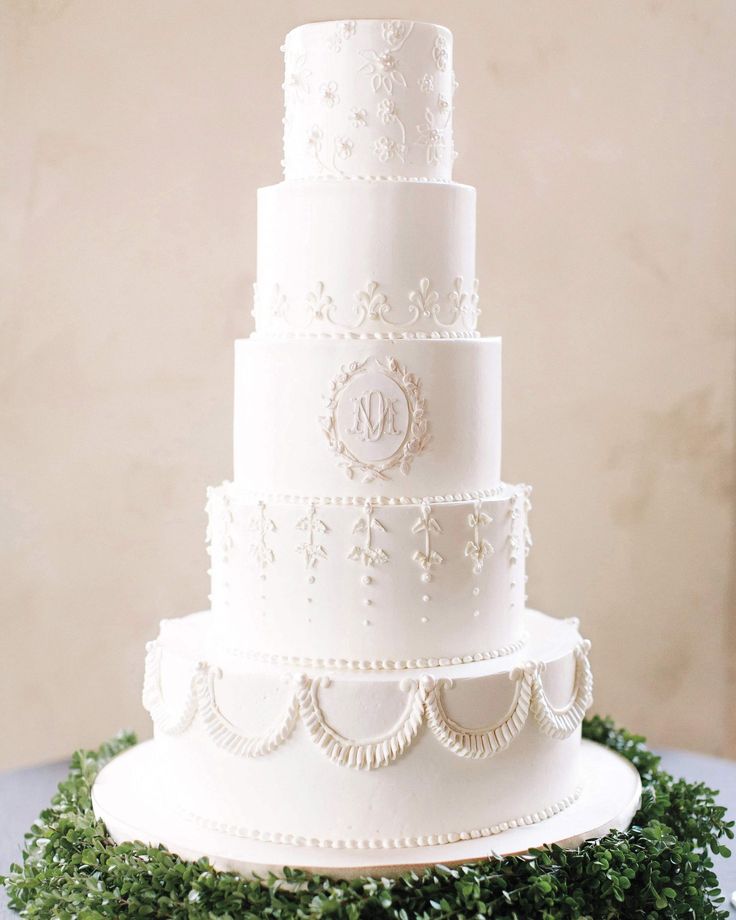 a white wedding cake sitting on top of a table