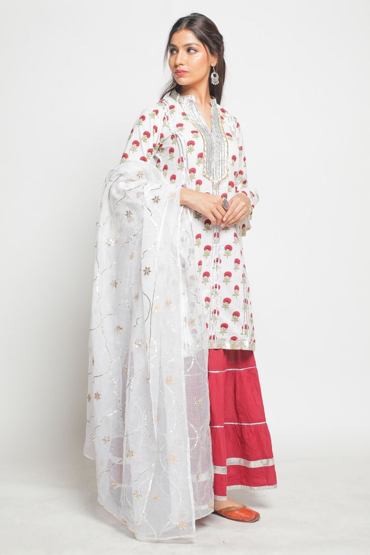 Ivory kurta with hand printed floral motifs. Comes with sharara and dupatta.
Component: 3
Neckine: Band collar
Sleeve Length: Three fourth
Fabric: Cotton
Color: White
Bell sleeves on kurta
Gota dhari work and handmade floral gota lace detailing on kurta
Marigold print with silver gota lace work on pant
 Hand worked gota jaal dupatta in hand spun kota doria - Aza Fashions Semi-stitched Sharara With Printed Motifs And Straight Kurta, Designer Sharara With Printed Motifs, Traditional Drape Sharara With Printed Motifs For Diwali, Designer Wear Sharara With Printed Motifs, Diwali Sharara With Traditional Drape And Printed Motifs, Diwali Sharara With Printed Motifs And Traditional Drape, Unstitched Chanderi Sharara With Printed Motifs, Chanderi Sharara With Printed Motifs For Festivals, Chanderi Sharara With Printed Motifs For Eid