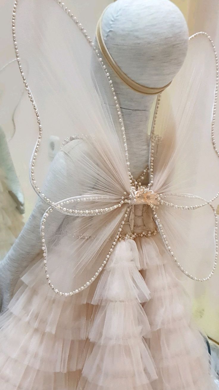 a dress made out of tulle and pearls