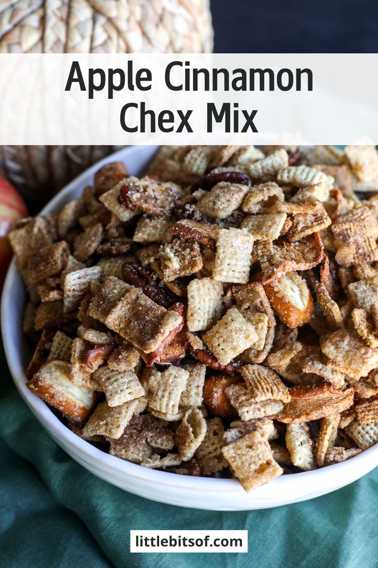 apple cinnamon chex mix in a white bowl on a green tablecloth with apples