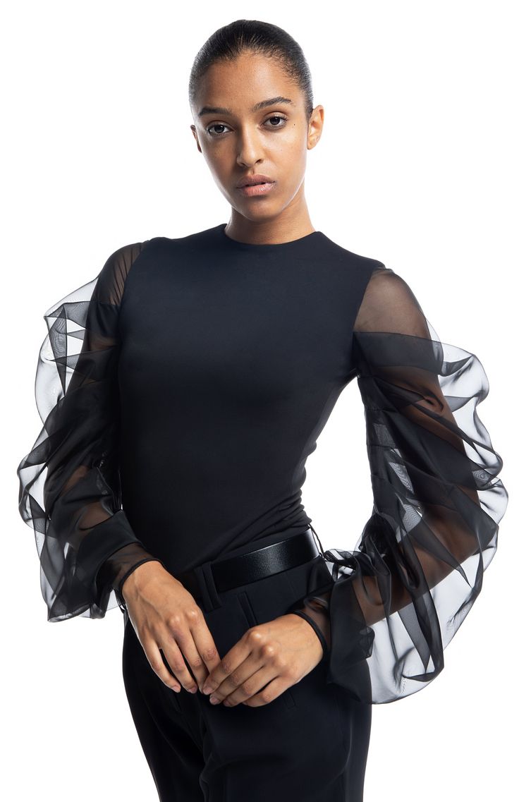 Preorder If Your Size Is Not Available. We'll Ship Within 7-10 Days. Styling: Tolemee is an elegant draped sleeve top. The fitted body is lined in the self-fabric for extra cover and comfort. The oversized sheer silk sleeves ensure you will steal all the attention every time you wear it. This is a versatile piece you can wear with skirts or pants. A true wardrobe staple you will enjoy for years to come. It looks great here worn over our Endless pants. Fit: The top is fitted, true to size, and th Fitted Silk Blouse With Draped Sleeves, Fitted Blouson Sleeve Party Tops, Evening Puff Sleeve Stretch Blouse, Fitted Evening Tops With Gathered Sleeves, Evening Fitted Top With Gathered Sleeves, Stretch Puff Sleeve Evening Blouse, Stretch Evening Blouse With Puff Sleeves, Stretch Puff Sleeve Blouse For Evening, Fitted Blouse With Gathered Sleeves For Evening