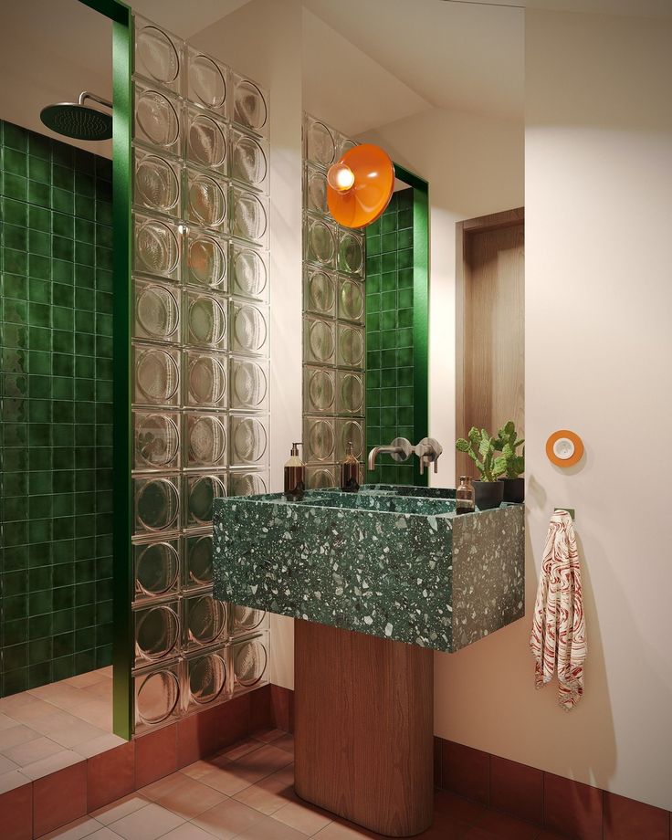 a bathroom with green tiles and a marble sink