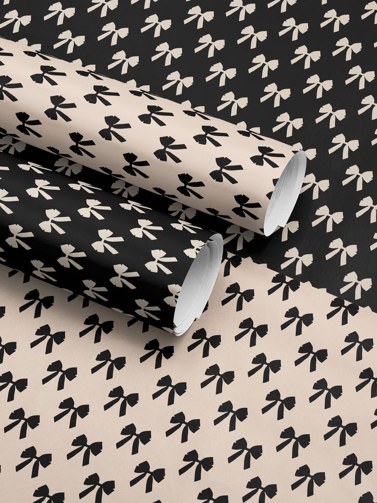 two black and white wallpapers with bows on them, one in the shape of an arrow