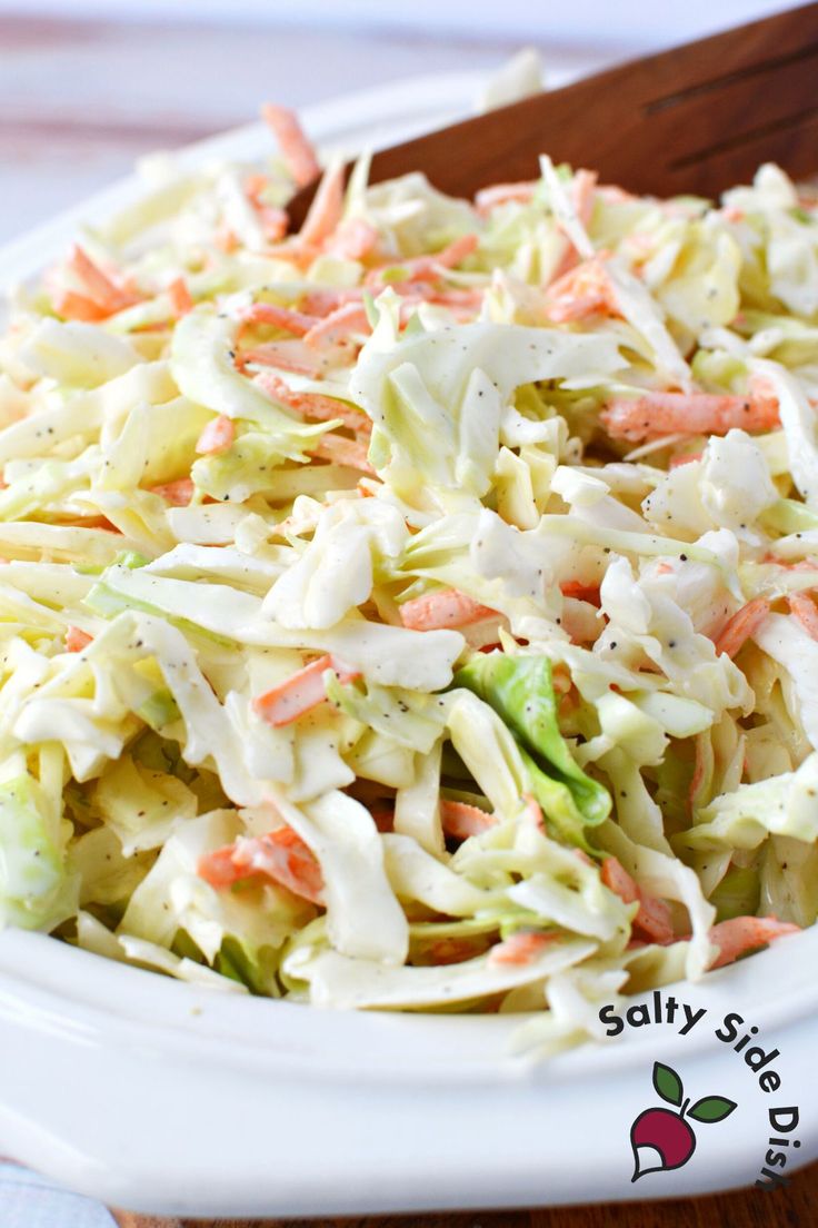 coleslaw salad with carrots and celery in a white bowl