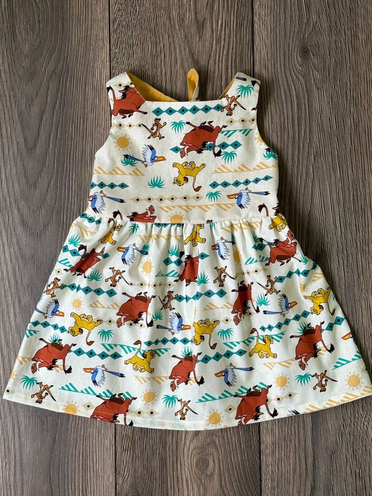 This dress is made from a lightweight and breathable cotton fabric. They have an elastic waist for comfort. making it perfect for the warmer months. It has a modern design with a fun print. Get this adorable dress made of natural cotton today! Lion King Dress, King Dress, Baby Girls Dress, Roi Lion, Toddler Gift, Le Roi Lion, The Lion King, Dress Party