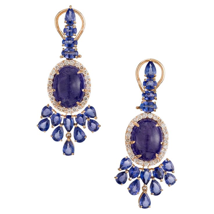 Spectacular Tanzanite, Sapphire and diamond dangle earrings. 2 vibrant oval cabochon tanzanite gemstones totaling 12.00cts are known for their exquisite blue-violet hue, are the centerpiece of these earrings. They are mounted in 18k yellow gold clip post settings, each with a halo of 25 round cut diamonds. The earrings are also adorned with pear and oval cut sapphires which are a deep rich blue color, creating a harmonious contrast. 2 oval cabochon purplish blue Tanzanite, approx. total weight 12.00cts, moderate inclusions, 12.50 x 9.94 x 7.13mm 50 round full cut Diamonds, approx. total weight 1.00cts, H, SI 6 oval blue Sapphires, approx. total weight 1.80cts, 4.4 – 5.2 x 3.2 – 3.5mm 22 pear blue Sapphires, approx. total weight 6.60cts, 3.6 – 5.2 x 3.1 – 3.8mm 18k rose gold Top to bottom: Rose Gold Top, Bleu Violet, Diamond Dangle Earrings, Blue Tanzanite, Tanzanite Gemstone, Oval Earring, Blue Violet, Dream Jewelry, Oval Cabochon