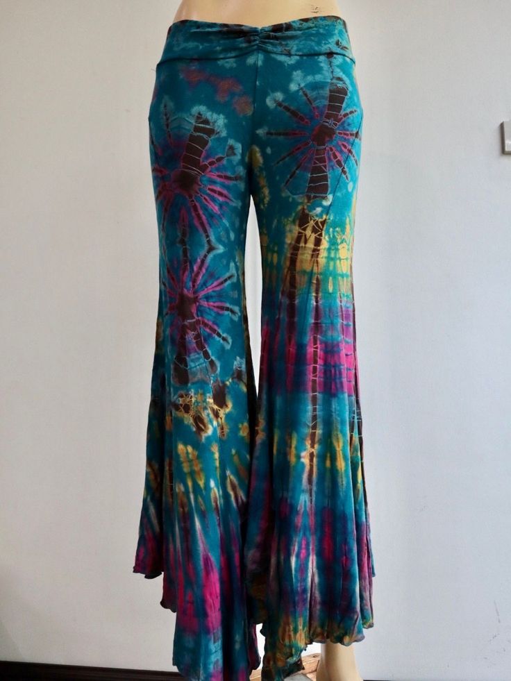 "Handmade Materials: Cotton, Lycra Description These tie dye splatter bell bottoms are made for movement! Perfect for yoga and flow activities. Handmade and hand-dyed, available from a variety of 4 colour ways to choose from 🌸 The fitting around the thigh is flattering & shaping until the material billows out at the knee into a wide flare. Featuring drawstrings on either side of the thigh that can be cinched for shape and length adjustment! The material consists of a quality Rayon 95% spandex 5 Fitted Hippie Flares For Summer, Blue Stretch Flares For Summer, Summer Stretch Blue Flares, Hippie Flare Bottoms For Festival, Hippie Flare Stretch Pants, Hippie Flared Festival Bottoms, Fitted Hippie Flare Pants, Hippie Flare Festival Bottoms, Hippie Fitted Flare Pants