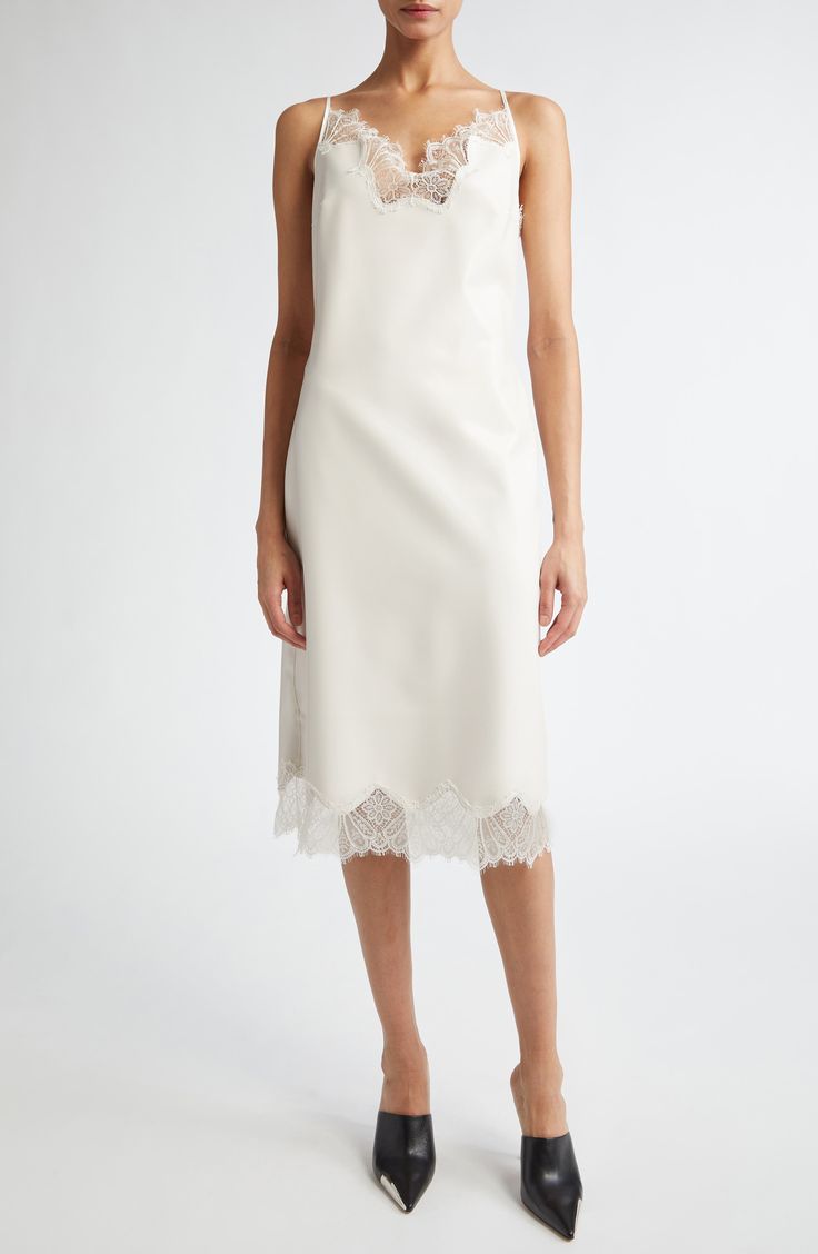 From the brand's prefall '24 collection, this slipdress leans into the classic lingerie look of an actual slip with its lace-trimmed neckline and hem. Where it redefines the style is in its construction from latex, giving it both a cling-free fit and a milky-white appearance. A polished metal Coperni logo is pinned at the center of the back. 38" center front length (size Medium) Slips on over head V-neck Adjustable straps Unlined Contains natural rubber latex Latex/silicone Hand wash, dry flat M Silk Spaghetti Strap Dress With Contrast Lace, Silk Dress With Spaghetti Straps And Contrast Lace, Silk Dress With Contrast Lace And Spaghetti Straps, Chic Formal Slip Dress With Lace Trim, Fitted Lace Trim Slip Dress For Formal Events, Formal Fitted Slip Dress With Lace Trim, Chic Evening Slip Dress With Lace Trim, Elegant Lace Midi Slip Dress, Chic Lace Slip Dress With Contrast Lace