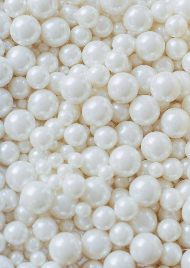 some white pearls are piled up together