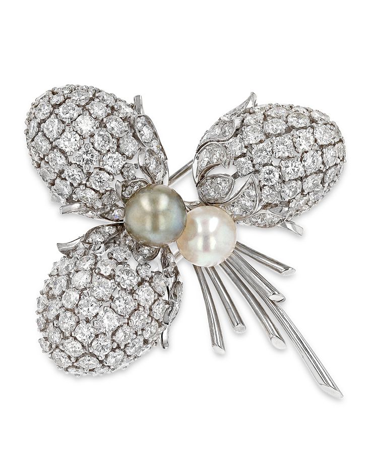 This elegant and retro pin features a combination of glittering white diamonds, totaling approximately 9.00 carats, and lustrous pearls. The asymmetrical arrangement and forms bring an evocative naturalism to the design. Created by the Parisian firm Sterlé, the brooch shines in its platinum settings. Pierre Sterlé founded his atelier in 1943 near the Place Vendôme in Paris. Operating by appointment only, his ingenuity and innovative designs attracted socialites and royals alike. His favorite mot Luxury White Diamond Brooch, Diamond White Gold Brooches For Evening, Evening Diamond White Gold Brooches, Elegant Diamond Brooches With Accents, White Brilliant Cut Brooches For Wedding, White Brilliant Cut Wedding Brooches, Classic White Diamond Brooches, Elegant Platinum Brooches With Diamond Accents, Elegant Diamond Brooches With Brilliant Cut