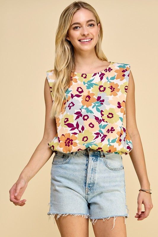 Sleeveless floral print top with elastic band at the bottom 100% Polyester Floral Print Summer Tank Top, Printed Sleeveless Spring Tops, Printed Sleeveless Tops For Spring, Casual Floral Print Sleeveless Tank Top, Multicolor Sleeveless Blouse Tank Top For Day Out, Summer Sleeveless Tops With Floral Print, Sleeveless Summer Top With Floral Print, Chic Floral Print Tank Top For Vacation, Chic Floral Print Tank Top For Beach