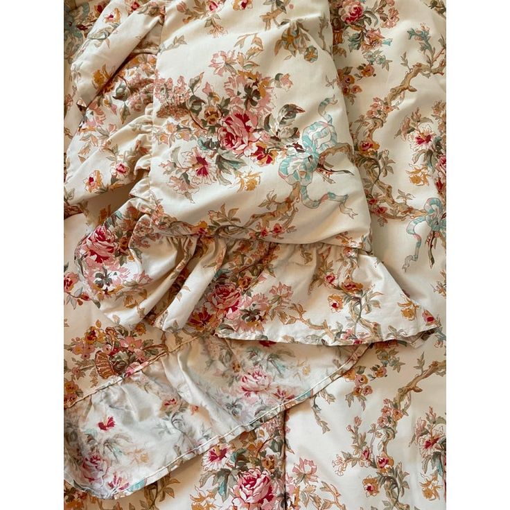 an image of a flowered bed sheet with ruffles and flowers on it