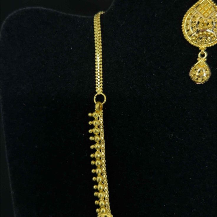 Purity Info will be here 22K Yellow Gold Weight 42.58 Gm Dimension: Necklace: 16in L Product detail: Product Code: NEAR-1301142 Color: Yellow Gold Product Type: Necklace and Earring Set Age Group: Adult Gender: Female Availability: In Stock Country Of Origin: India Product description: 22k gold necklace and earring set. Necklace measures 16 inches in length. Screwback filigree earrings measure 44mm in length. Central pendant measures 62mm from top to bottom. Necklace and earrings feature many tr 22k Yellow Gold Filigree Bridal Necklace, Yellow Gold Plated Filigree Jewelry Sets, Gold-plated Yellow Necklaces With Intricate Design, Traditional Yellow Gold Filigree Danglers, 22k Gold Filigree Yellow Necklaces, 22k Gold Necklace, Filigree Earrings, Gold Filigree, Mala Necklace