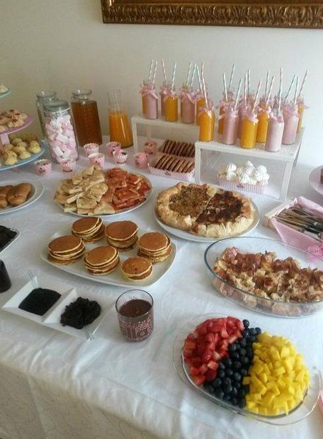 a table topped with lots of food and desserts