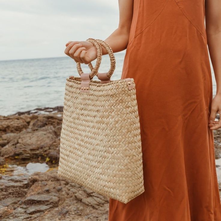 We've officially entered our resort era, and we're bringing along the handwoven Sun-Seeker tote with its modern sophistication to spring and summer days. The oversized rectangular design allows for plenty of room to carry your essentials and more, plus the detachable strap gives you the option of two completely different styles - a boho crossbody by day and statement purse by night. The leather detailing on the straw purse has been organically dyed in a blush hue and finished with matte gold hardware. Each handmade bag is unique and may have small imperfections or vary in size and color. All Leah products are responsibly sourced and ethically crafted. • Made in Mexico• Dimensions: 14 x 4.5 x 16 in (35.6 x 11.4 x 40.6 cm) • Organic and Plastic-free • Ethically sourced Gold Har, Statement Purse, Straw Purse, Everyday Purse, Straw Tote, Skin Care Gifts, Handmade Hat, Crossbody Tote, Hat Band