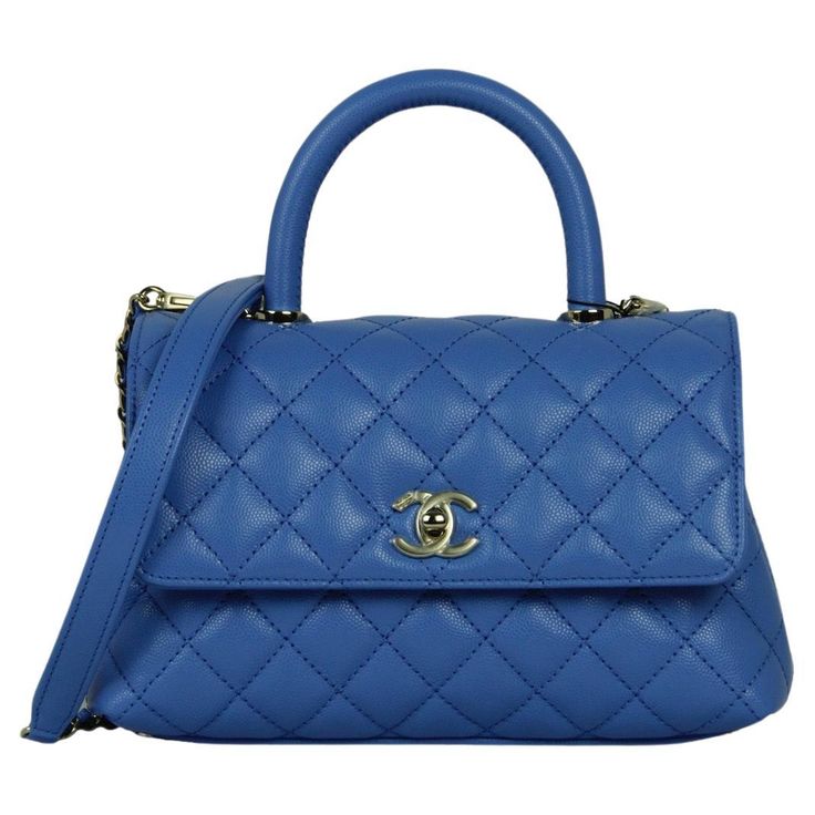 Chanel Blue Caviar Leather Quilted Mini Coco Handle Flap Bag Made In: Italy Year of Production: 2024 Color: Blue Hardware: Pale goldtone Materials: Caviar leather Lining: Leather Closure/Opening: Flap top with CC twist lock Exterior Pockets: Back patch pocket Interior Pockets: Two compartments separated by zipper pocket, patch pockets, and a central zipper compartment.  Exterior Condition: Excellent, like new. Protective plastic still on hardware.  Interior Condition:  Excellent, like new Includes: Dustbag, tag Measurements: 9"L x 5.5"H x 3.5"D Handle Drop: 2.75" Strap Drop: 18" Cheap Blue Top Handle Box Bag, Chanel Coco Handle, Chanel Top, Chanel Blue, Coco Handle, 2024 Color, Knitted Romper, Prada Handbags, Blue Pearl