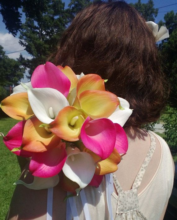 a woman holding a bouquet of flowers in front of her face