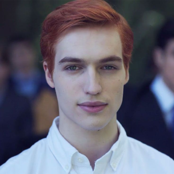 a man with red hair wearing a white shirt