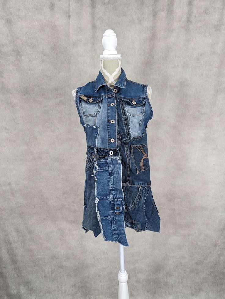 "Upcycled denim patchwork vest with frayed seams and jagged hem. Bust measures 34\" when buttoned. Length varies from 26\"-33\"." Patchwork Denim Sleeveless Vest, Sleeveless Patchwork Denim Vest, Medium Wash Patchwork Cotton Denim Vest, Medium Wash Patchwork Denim Vest, Patchwork Vest, Jeans Patchwork, Upcycled Jeans, Diy Denim, Blue Jean Outfits