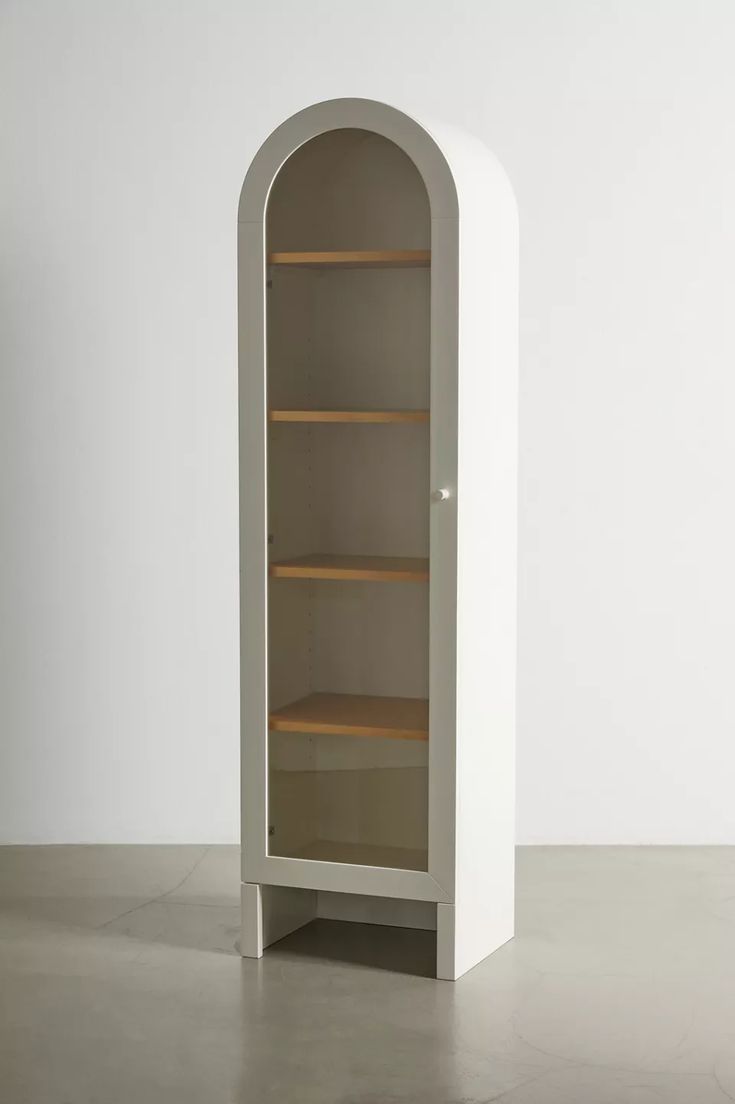 a white bookcase with shelves in the middle and one shelf on the other side