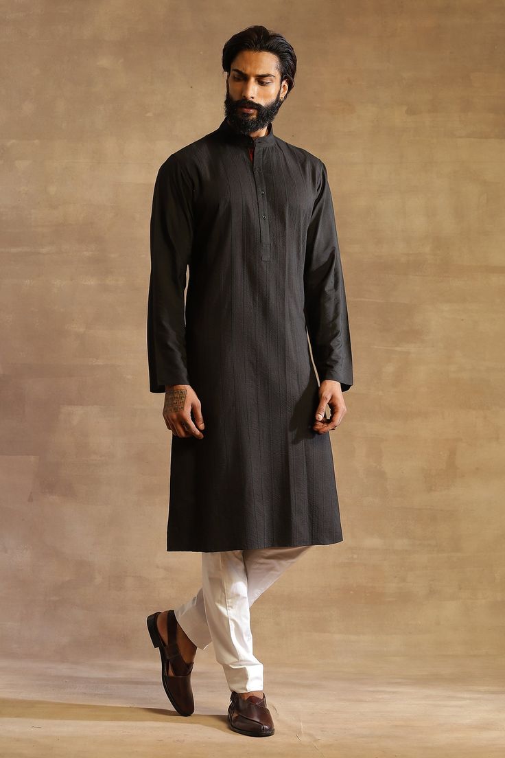 Black silk long kurta with pintucks and stitch lines front textures.
Component: 1
Pattern: Embroidered
Type Of Work: Stitch Line
Neckline: Band Collar
Sleeve Type: Full
Fabric: Silk
Color: Black
Other Details: 
Front button placket
Striped pattern
Note: Pant worn by the model is not for sale
Occasion: Sangeet - Aza Fashions Long Kurta For Men, Kurta Black, Raghavendra Rathore, Black Stitch, Kurta For Men, Long Kurta, Line Texture, Stitch Lines, Band Collar