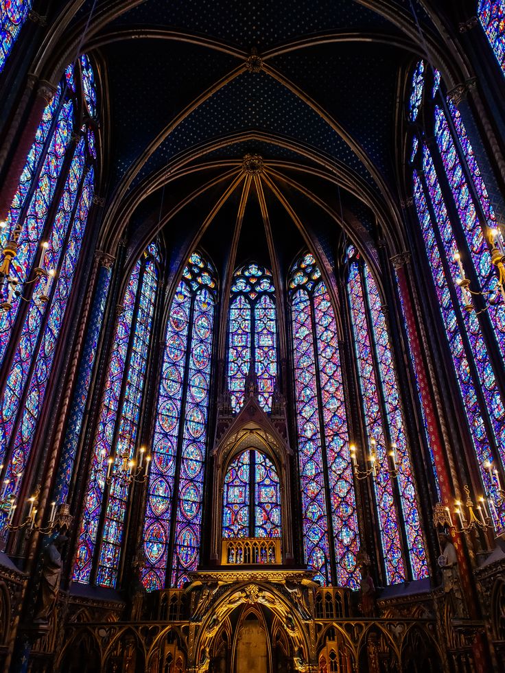 the inside of a cathedral with stained glass windows