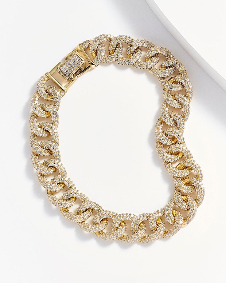 Purely divine, the Lorena Curb Chain Link Bracelet is a stunning accessory fit for royalty. Sheerly elegant, the elongated curb link design made from 14k gold plating over genuine sterling silver is completely encrusted in countless clear diamonettes, lending an utterly dazzling effect. An ideal selection for adding more distinction to your evening attire, this fancy piece is a must for any woman who needs to stand out in style. Fine dining, theater, opera, weddings, galas and more, it is a lege Luxury Rectangular Cable Chain Bracelets, Luxury Gold-tone Link Jewelry, Luxury Elegant Sterling Silver Curb Chain Bracelet, Luxury Rectangular Curb Chain Jewelry, Fine Jewelry Gold Chain Link, Elegant Gold Chain Bracelet With Diamond Accents, Luxury Diamond Bracelets With Gold Chain, Luxury Diamond Bracelet With Gold Chain, Crystal Cuban Link Jewelry With Adjustable Chain