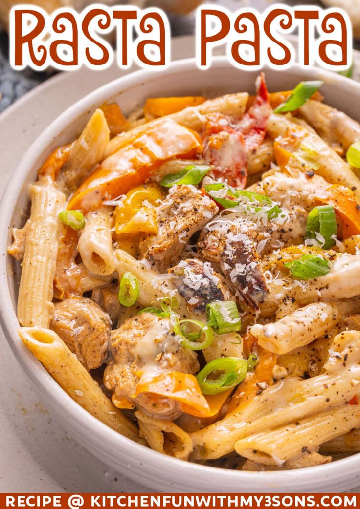 pasta with chicken, peppers and cheese in a white bowl on top of a table