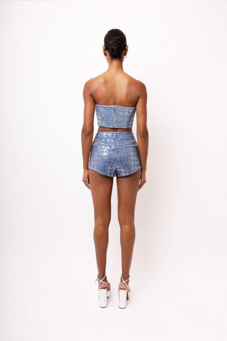 Sequin embellished hotpant shorts.  Classic blue wash.  High rise.  Five pockets.  Front fly fastening. Pair with our Theo Denim Cropped Sequin Top﻿ 70% Cotton, 30% Polyester. Lining: 100% Cotton. Cool hand wash only. Glamorous Bottoms With Built-in Shorts, Sequin Denim Bottoms For Spring, Glamorous High Rise Bottoms For Night Out, Glamorous Fitted Shorts, Fitted Glamorous Short Bottoms, Glamorous Fitted Short-length Bottoms, Glamorous Fitted Short Length Bottoms, Blue Denim Sequined Bottoms, High-waisted Sequin Shorts For Summer