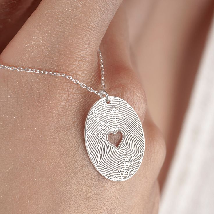 Fingerprint Jewelry, Silver Heart Stamped Necklace in Sterling Silver is made by hand in our workshop with care. All our jewelry is the most elegant choice for the Bridesmaids, friends, your loved ones and for yourself. Fingerprint Jewelry, Silver Heart Stamped Necklace * Material: High Quality Solid 925 Sterling Silver. * Dimensions: Depending on your font choice, height sizes range from 1,5 mm to 3,5 mm lowercase. * Finish: Sterling Silver ∙ Gold ∙ Rose Gold. HOW TO ORDER ❓ * Select your neckl Etched Heart-shaped Jewelry For Valentine's Day, Etched Heart Jewelry For Valentine's Day, Valentine's Day Etched Heart Jewelry, Heart-shaped Etched Necklaces For Valentine's Day, Elegant Stamped Heart-shaped Jewelry, Heart-shaped Etched Jewelry For Keepsake, Engraved Round Pendant Heart Necklace For Weddings, Heart-shaped Etched Keepsake Jewelry, Valentine's Day Heart-shaped Etched Necklaces