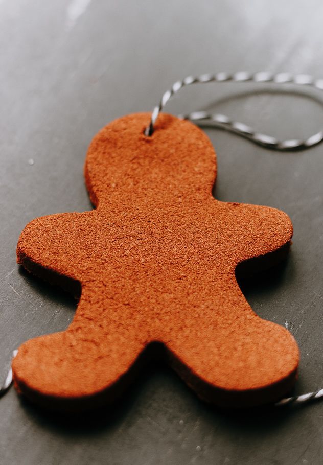 a wooden ornament with a chain attached to it sitting on a counter top