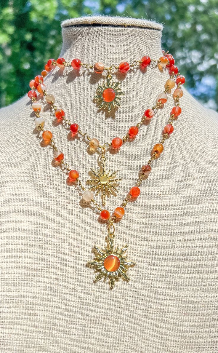 "Carnelian Sun Charm Wire Wrapped Gold Necklace/Crystal Beaded Gold Sun Choker/Gemstone Necklace/Sun Choker/Hippie Choker/Crystal Jewelry - Choker style crystal necklace with Carnelian Crystal faceted Beads and sun charm - Length is 16\", 17\" or 18\"  - Materials: Gold plated copper wire, natural Carnelian crystals and, brass charm Check other styles in my shop: https://www.etsy.com/listing/1442563528/green-aventurine-wire-wrapped-gold?click_key=4cabd233646d7a1b40aaad5054c9b30ae6e57b71%3A144256 Beaded Dangle Crystal Necklaces For Festivals, Orange Spiritual Jewelry For Beach, Adjustable Carnelian Jewelry With Colorful Beads, Orange Bohemian Crystal Necklace With Natural Stones, Bohemian Orange Crystal Necklace With Natural Stones, Gold Agate Beaded Crystal Necklaces, Gold Beaded Agate Crystal Necklaces, Bohemian Adjustable Gemstone Charm Necklaces, Bohemian Adjustable Gemstone Charm Necklace