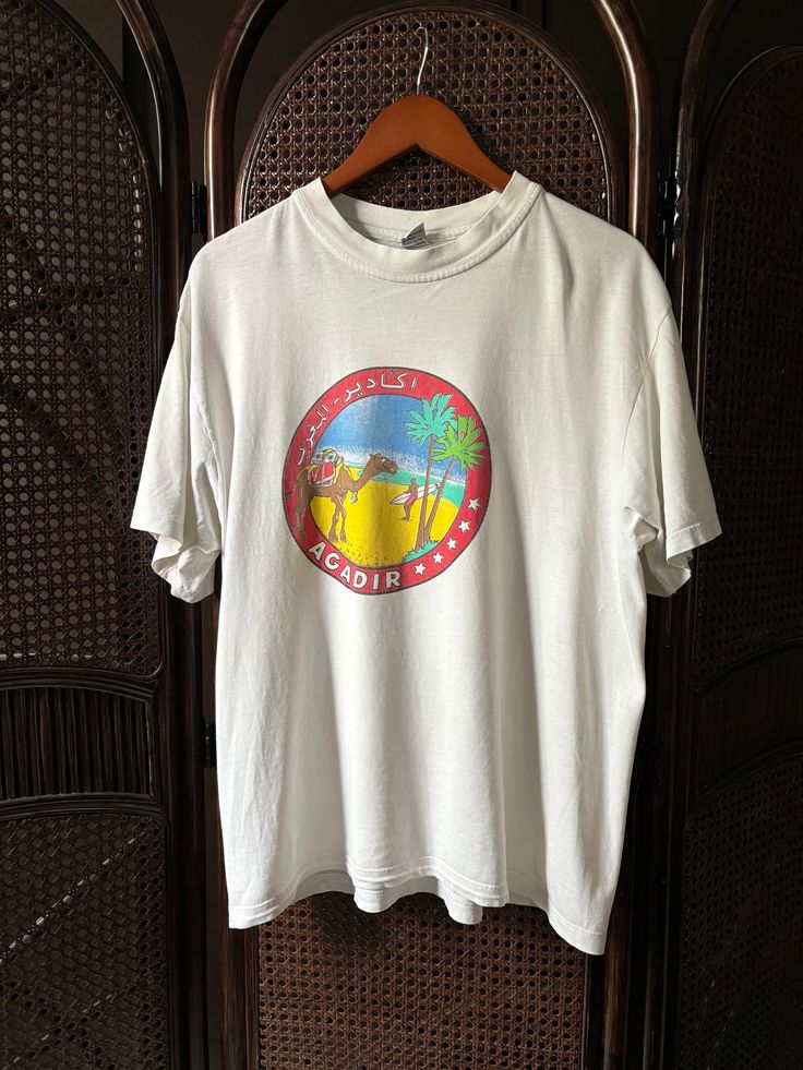 Vintage Agadir Morocco T Shirt Chest 21 Length 27 Size Large Good Condition ❌defect There are stains as shown in the picture. Please look at the pictures before making a purchase 🛫1-4 days after purchase will deliver Delivered by Thailand Post, free shipping 🧺The product has been cleaned Y2k Printed Crew Neck T-shirt, Retro Short Sleeve Printed T-shirt, Retro Printed Short Sleeve T-shirt, 90s Style Short Sleeve Screen Print Shirt, Vintage Printed T-shirt For Summer, 90s Style Screen Print Short Sleeve Shirt, 90s Style Pre-shrunk Short Sleeve Shirt, Vintage Print Relaxed Fit Short Sleeve T-shirt, Relaxed Fit Vintage Print T-shirt