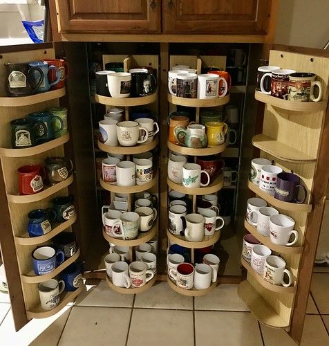 the shelves are filled with cups and mugs