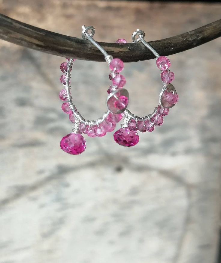 Pink Topaz Earrings November Birthstone A lovely selection of pink topaz gemstones are used for making of these creole earrings. The hoops are 20mm before wrapping and the earrings measure 1.3 inch including the drop. All wires are sterling silver. The piece comes wrapped in a gift box and securely packaged for shipping. Topaz Metaphysical Properties: * Communication * Love * Good fortune * Good health * Attraction Chakras - Sacral Chakra, Solar Plexus Chakra Zodiac - Leo, Scorpio, Sagittarius Pink Sterling Silver Hoop Earrings For Anniversary, Pink Small Hoop Jewelry For Anniversary, Pink Gemstone Round Earrings, Pink Sterling Silver Small Hoop Earrings, Pink Hoop Earrings For Anniversary, Pink Round Tourmaline Jewelry, Pink Sterling Silver Hoop Earrings, Small Pink Hoop Earrings For Anniversary, Pink Tourmaline Dangle Jewelry