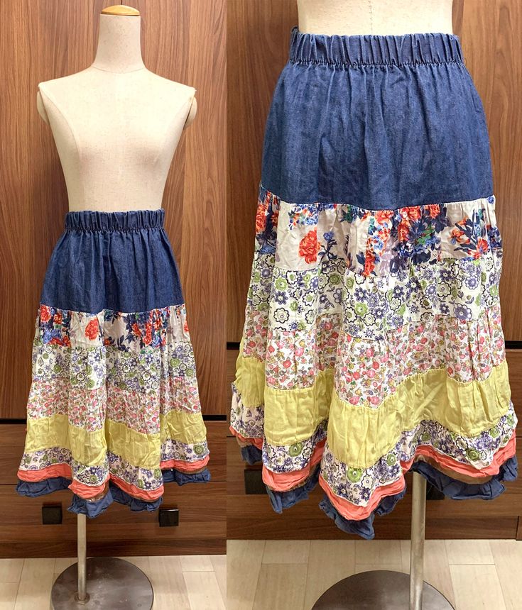 A sweet vintage patchwork midi skirt with wide mixed print horizontal panels. There is a blue jean panel at the top, layered with floral printed cotton panels and yellow cotton panel. This item has been laundered and is ready for wear. - Minor scratches on the fabric - Pre-owned one with signs of wear  - Size: Free Size Total Length: 27.5" Waist: From 24" (can extend to 36" - Measures 18" across when flat) Hips: 44" - Measures 22" across when flat - Good vintage condition - Shipping Time: US (EA Spring Denim Patchwork Skirt, Bohemian Blue Long Denim Skirt, Bohemian Long Blue Denim Skirt, Bohemian Blue Cotton Denim Skirt, Casual Long Skirt With Floral Patchwork, Blue Bohemian Cotton Denim Skirt, Bohemian Blue Denim Skirt For Spring, Cotton Midi Skirt With Patchwork, Patchwork Cotton Midi Skirt