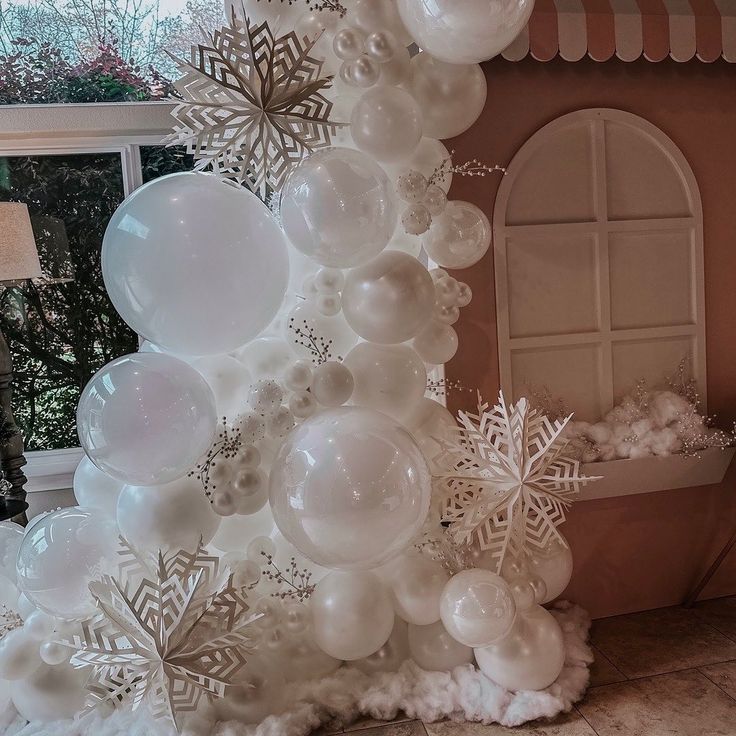 a white christmas tree made out of balloons and snowflakes