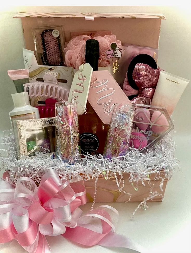 a pink gift box filled with lots of personal care products and gifts for someone's special occasion