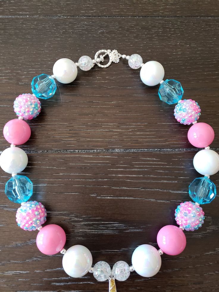 a bracelet with pink, white and blue beads