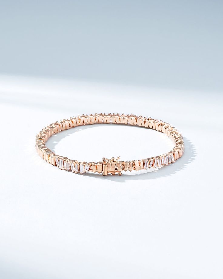 Crafted in 18-karat gold, this tennis bracelet incorporates our beloved baguette diamonds unevenly set while interchanging them with sections of gold all the way around. We love this piece for its seamless design and everyday wearability. The perfect baguette tennis bracelet to instantly elevate any outfit, casual or formal. Details 18k yellow gold, rose gold or white gold 2.00 carats of baguette white diamonds Bracelet measures 7" inches in length Box clasp with safety lock fastening Model is s Modern Baguette Cut Tennis Bracelet For Anniversary, Fine Jewelry Rose Gold Diamond Bracelet With Baguette Cut, Rose Gold Baguette Cut Diamond Bracelet, Modern Diamond Tennis Bracelet With Baguette Cut, Luxury Rose Gold Baguette Cut Bracelets, Modern Wedding Tennis Bracelet With Baguette Diamonds, Modern Tennis Bracelet With Baguette Diamonds For Wedding, Timeless Everyday Luxury Diamond Bracelet With Baguette Diamonds, Timeless Everyday Luxury Tennis Bracelet With Baguette Diamonds