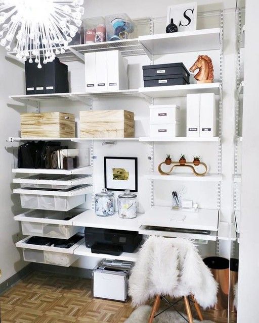 a white shelving unit filled with lots of boxes and other items on top of it