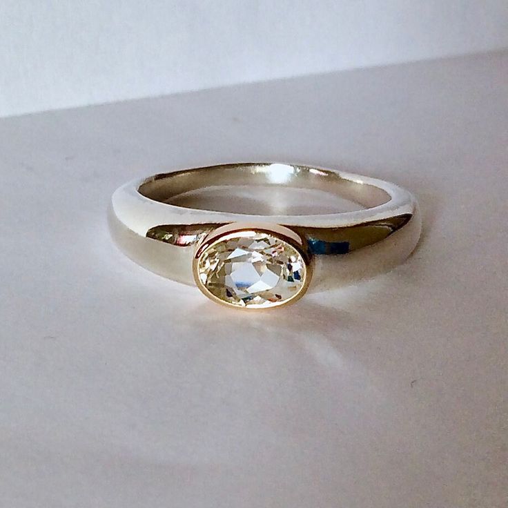 This White topaz oval ring is so beautifully simple and elegant ! It is a wonderful ring to stack with other rings and of course looks great on it's own.  The ring is made in sterling silver and the setting is 14kt gold. The white topaz is fine quality and very clean and well cut.  The stone is 5x7mm.  This ring can be ordered in different sizes and with different stones. Oval Ring, Oval Rings, Jewelry Inspo, Stackable Rings, White Topaz, 14kt Gold, Solitaire Ring, Topaz, Jewelry Rings